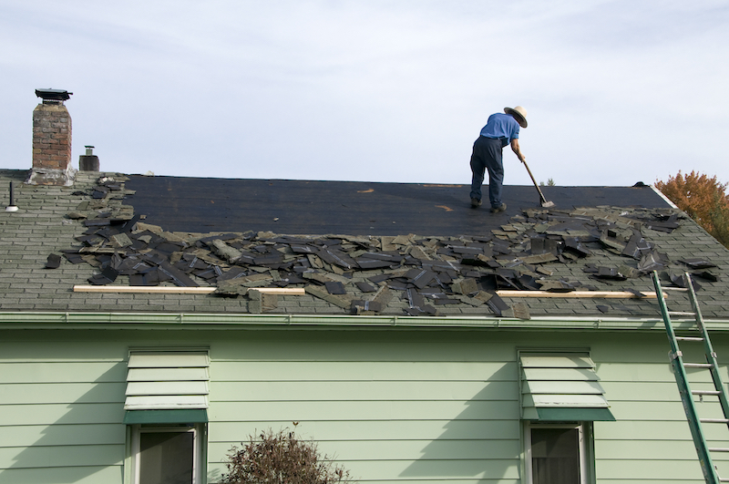 Collingwood roofers removing old shingles to prepare a roof for a new installation