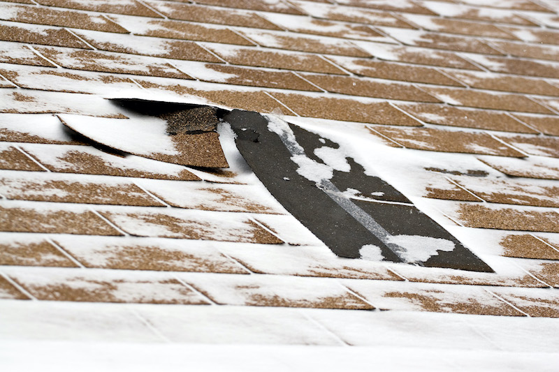 A close-up picture of a missing roof shingle due to ice and snow