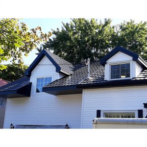 A picture of a black metal roof on a white house