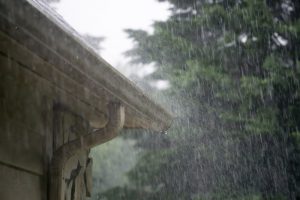 A picture of a roof experiencing a heavy rain downfall