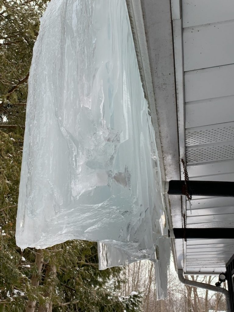 an ice damn being fixed by Ainger Roofing, a barrie roofing companies