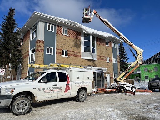 Ainger's roofing in barrie service team performing ice damn removal.