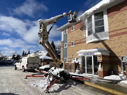 ainger's roofing in barrie team working on aroff in barrie's ice dam removal