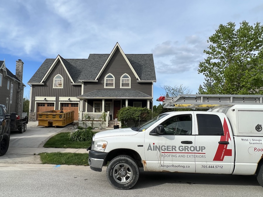 ainger truck parked in front of a new roof in barrie
