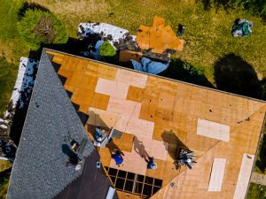 Aerial view of roof construction repairman on a residential apartment with new roof shingle being applied, roofing in barrie