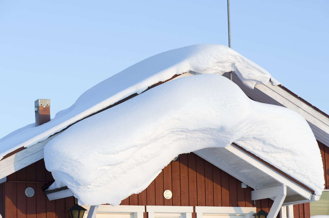 Snowdrift on canopy roof over the door.