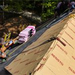Professional roofers installing shingles