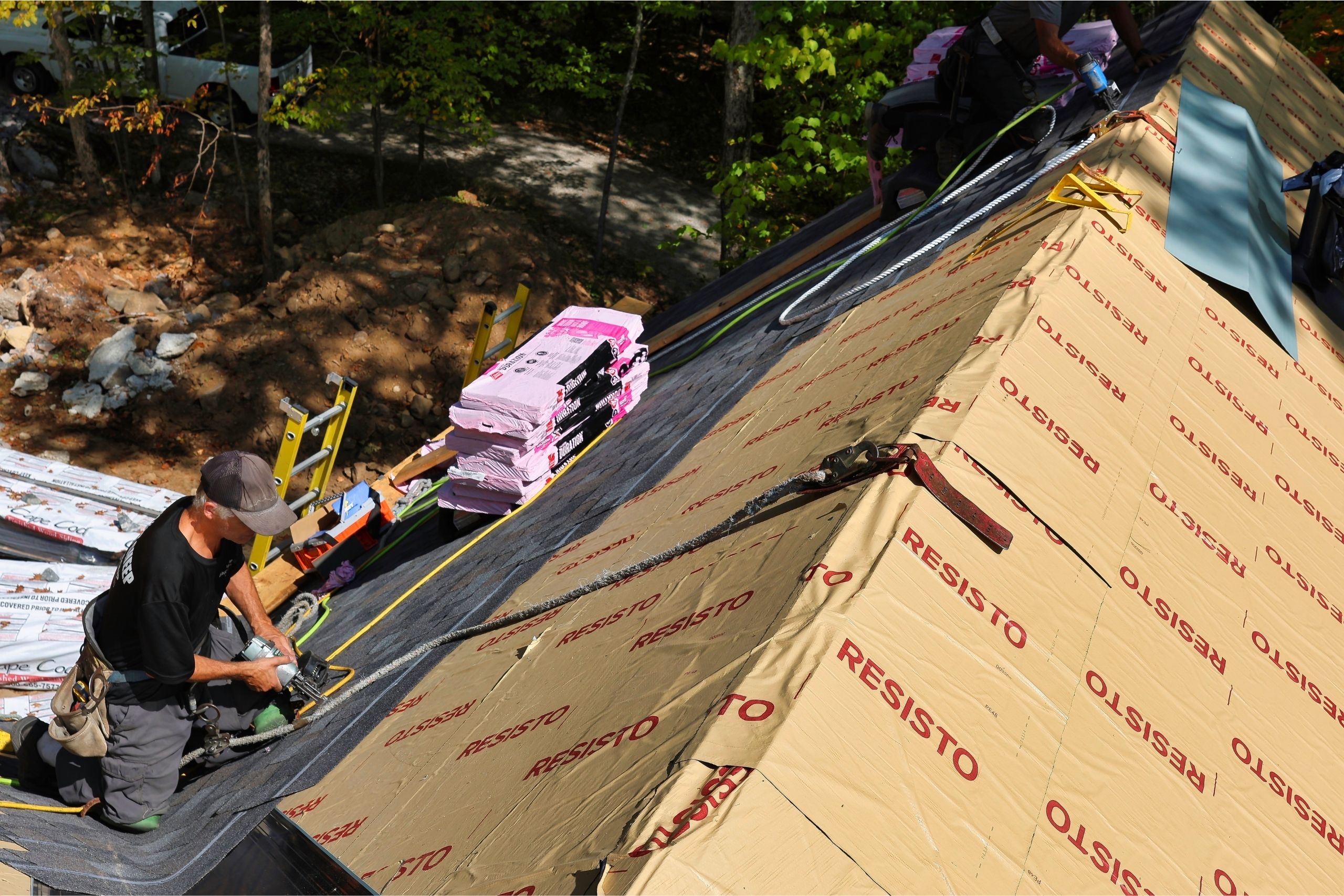 Professional roofers installing shingles