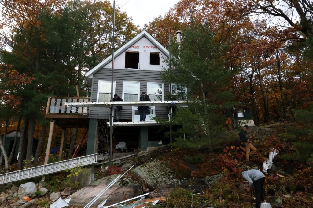 Homeowner performing skylight maintenance before winter on a Collingwood roof