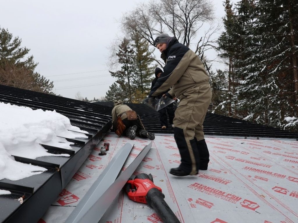 Metal roofers installing a new metal roof