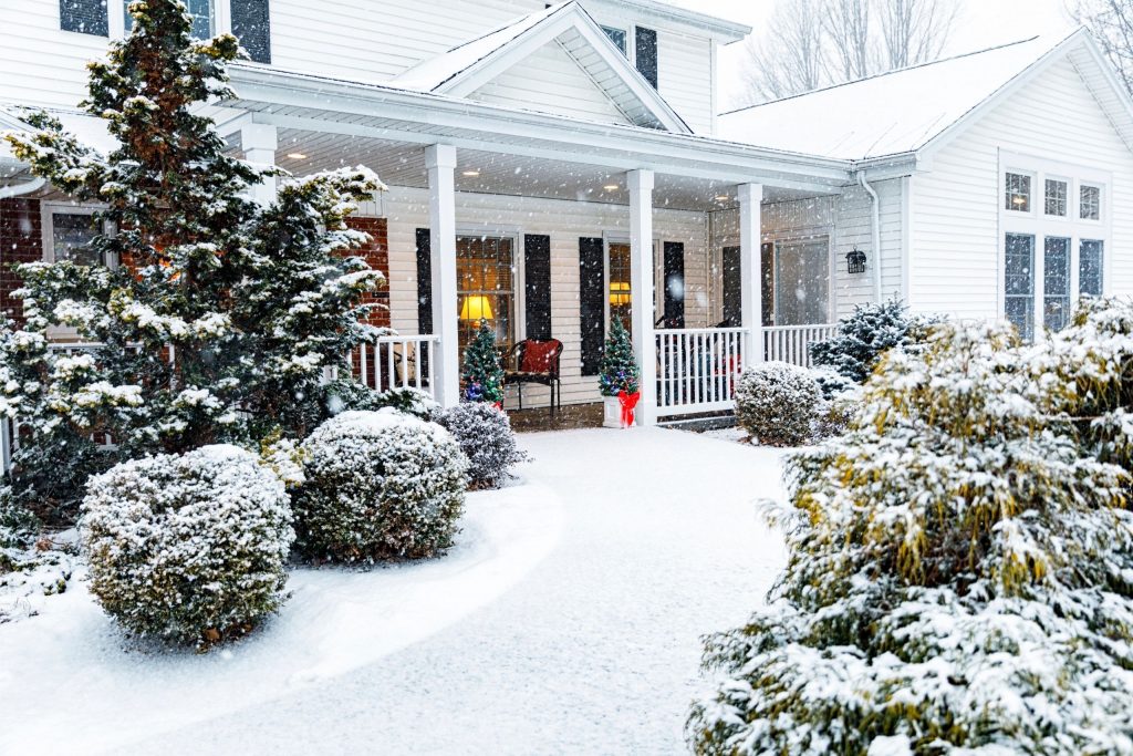 House in the winter with the rooftop covered in snow