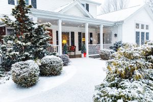 House in the winter with the rooftop covered in snow