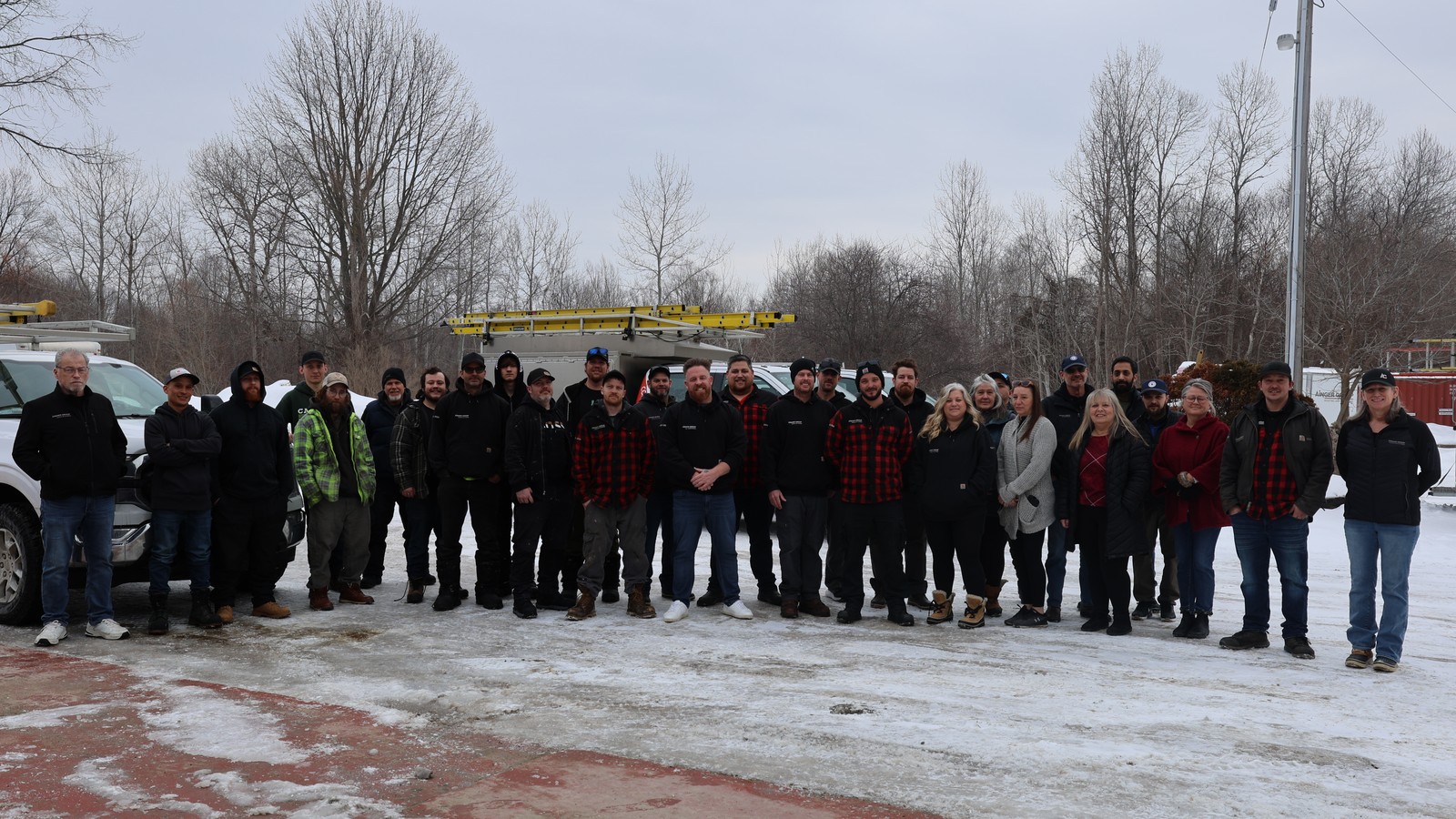 Ainger Group team gathered outside its Collingwood office during winter.