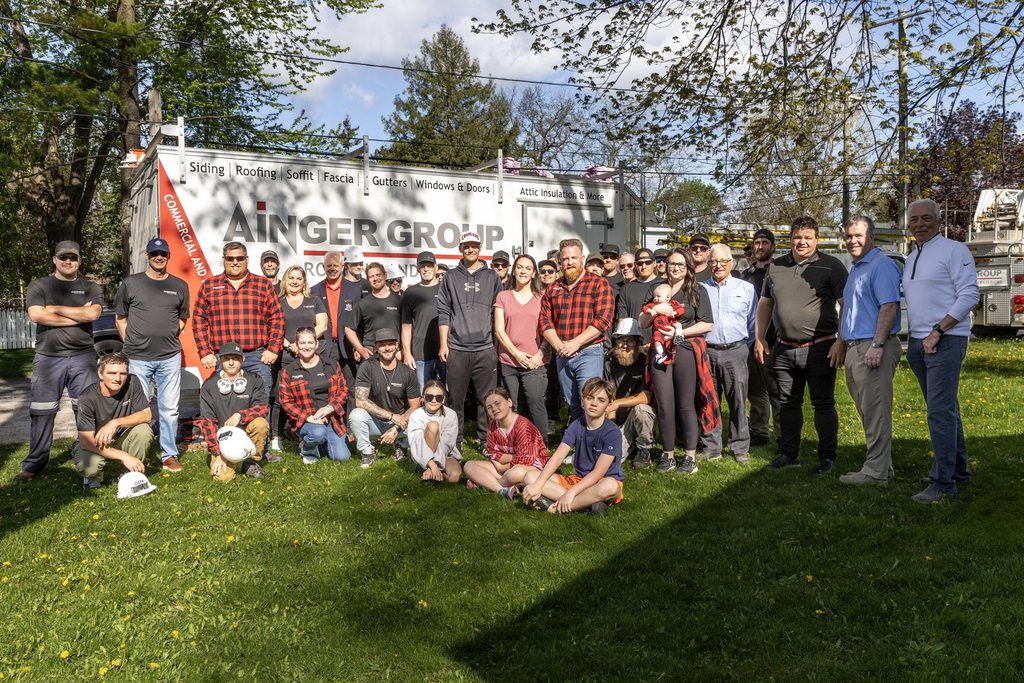 Ainger Group employees and community members gathered during a Roof Rescue project.