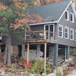 Finished Ainger siding project on a wooded lakeside cottage in Muskoka.